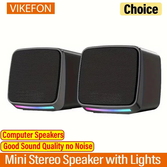 Mini speaker with colorful lights on a desk next to a laptop