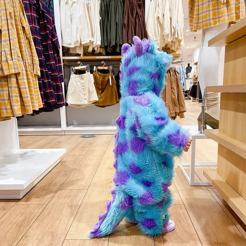 Adorable baby in a hooded animal-print jumpsuit lying on a soft blanket